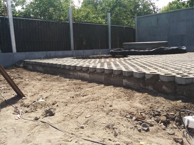 grass paver blocks laid on an elevated sand base during outd