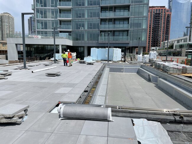 Commercial rooftop pool and terrace under construction.