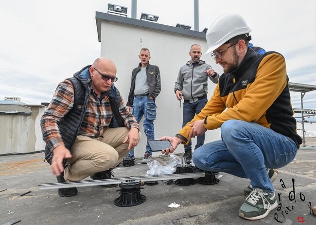 construction engineers and workers inspect adjustable pedest