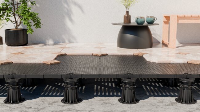 DeckSafe adjustable pedestal support system installed beneath drainage subfloor panels and patio pavers.